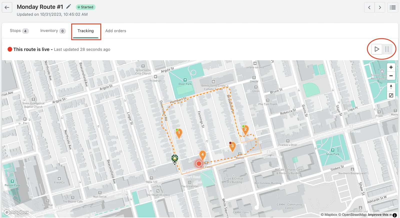 The Tracking tab of Monday Route #1, outlined in red, showing “This route is live”, a red dot near stop 4, and the play and pause buttons circled