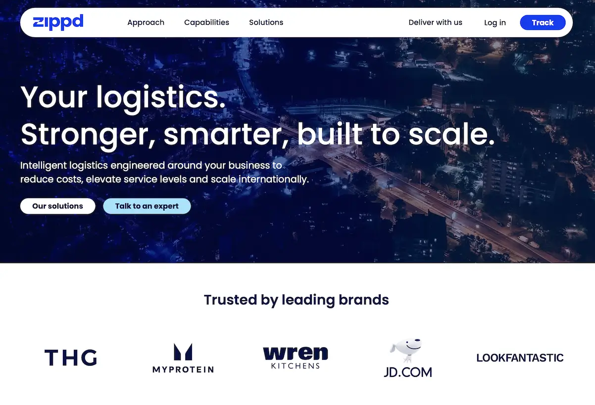 The Zippd home page with the headline “Your logistics. Stronger, smarter, built to scale.” over a city at night, above a row of brand logos