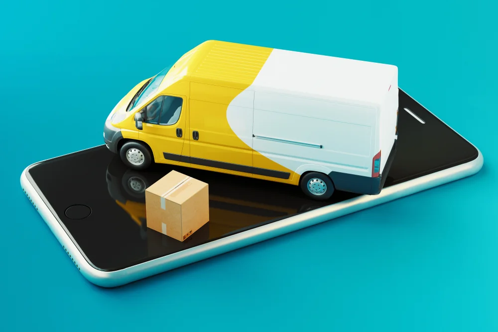 A yellow and white delivery van and a cardboard box standing on a smartphone screen